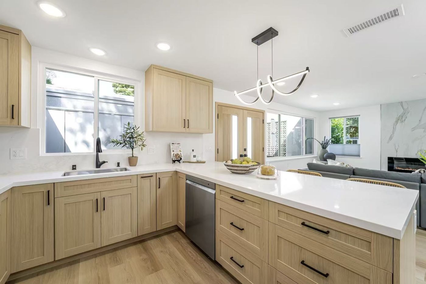 Modern oak shaker kitchen with white quartz peninsula
