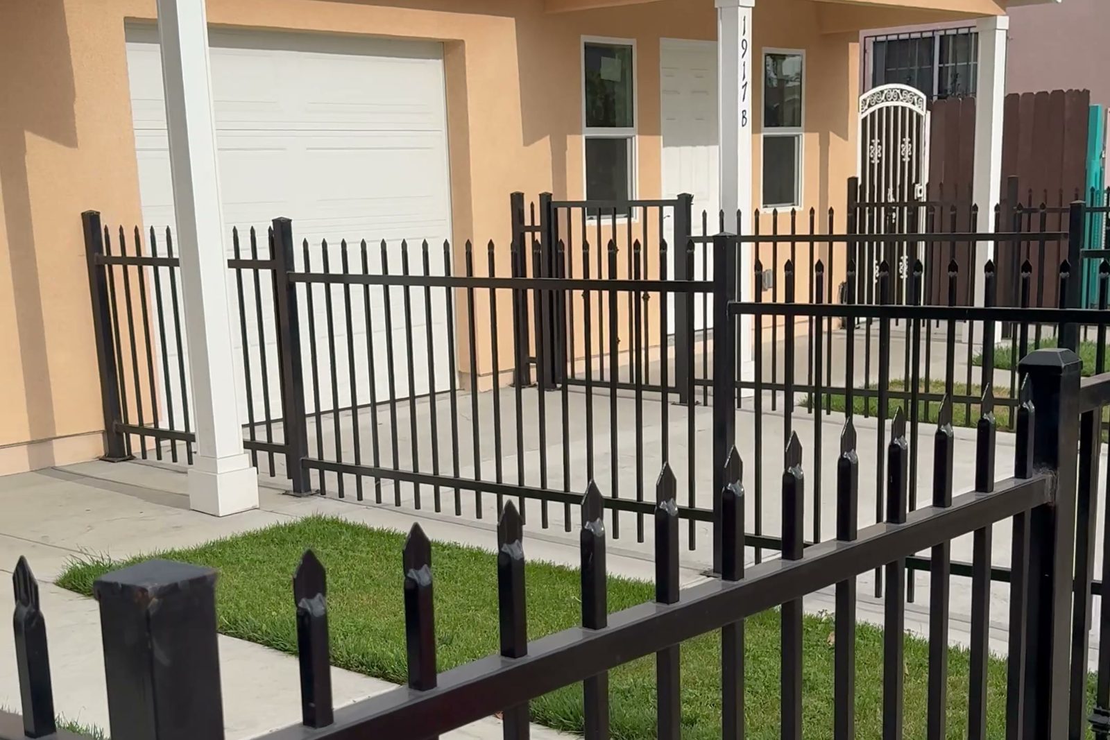 Finished ADUs with the garage between them and a fenced front yard