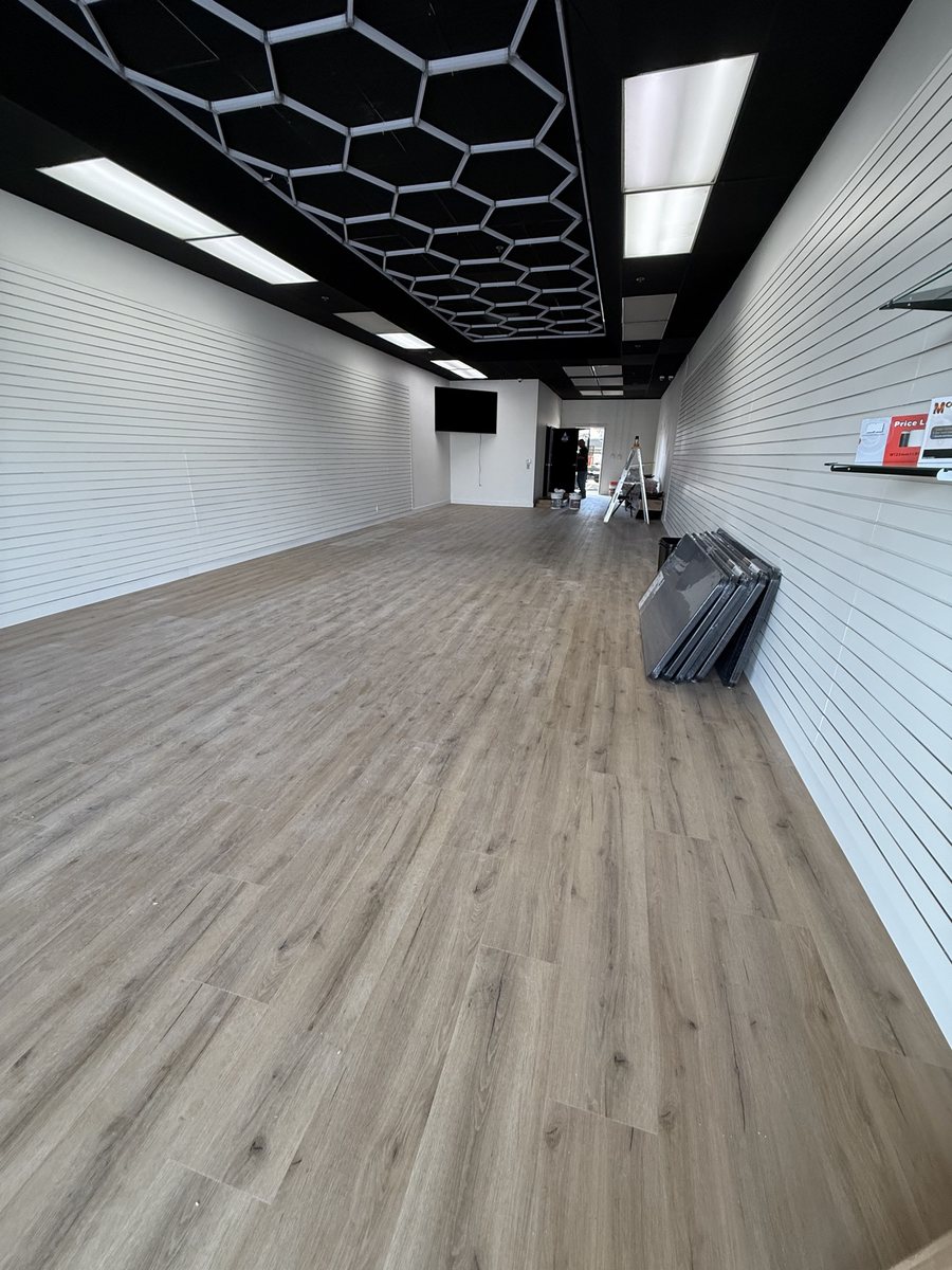 Black ceiling, hex lights and slatwall