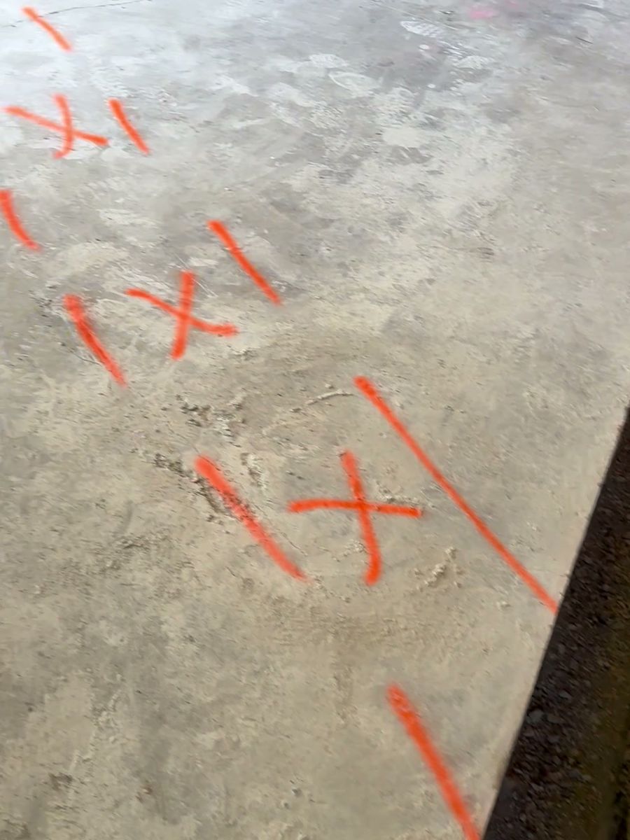 Plumbing layout marked on the garage slab