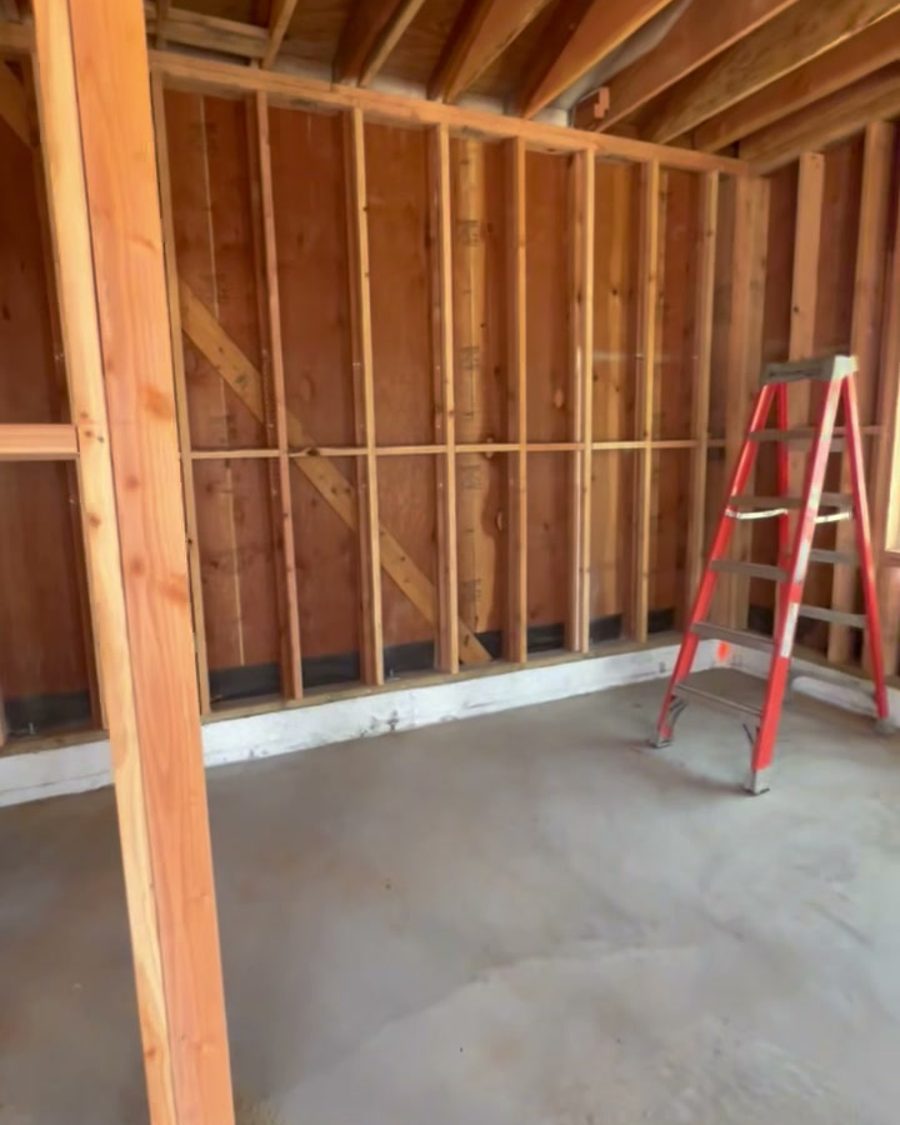Before: the open garage shell with exposed framing