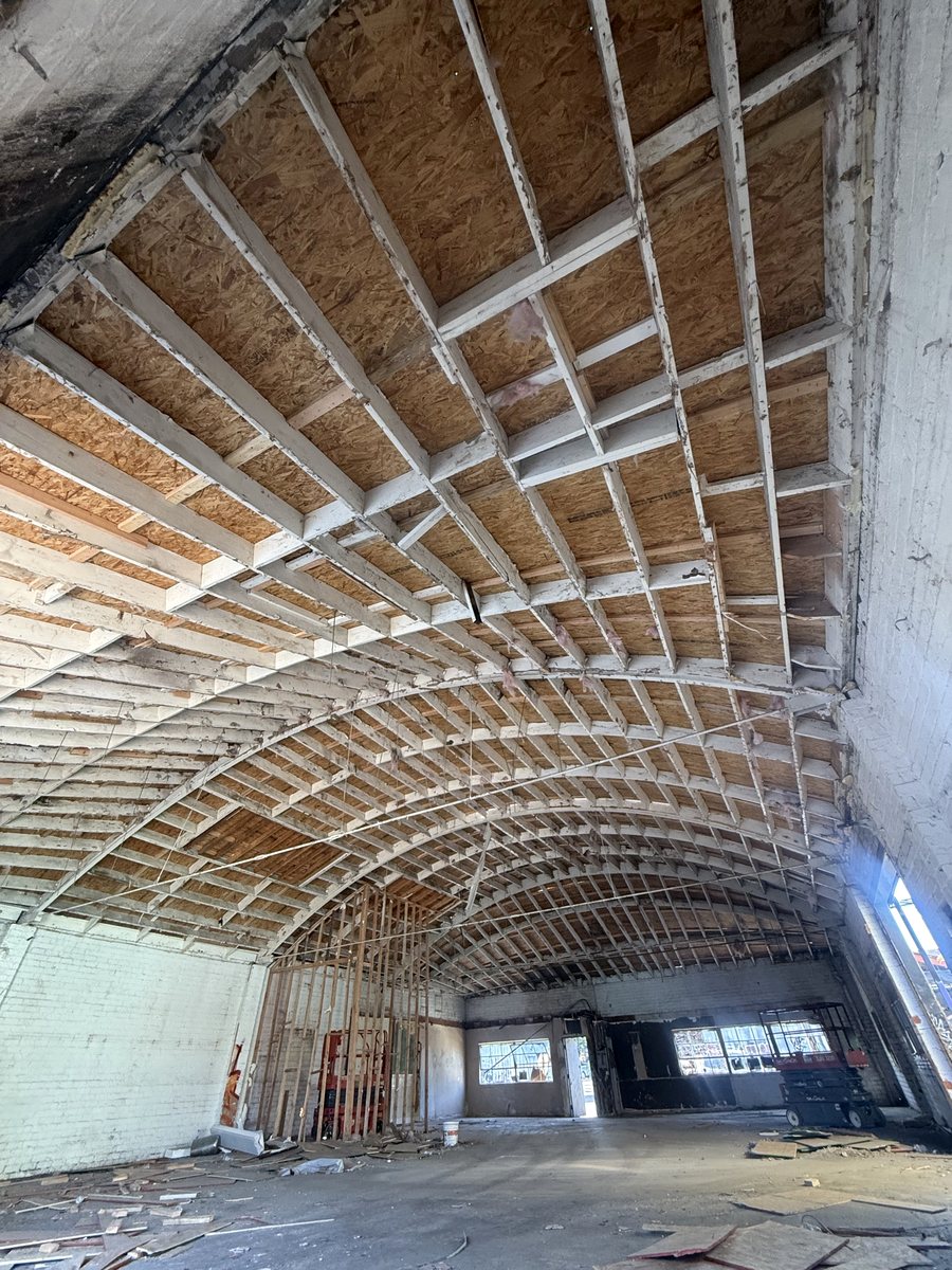 New roof framing across the arched trusses