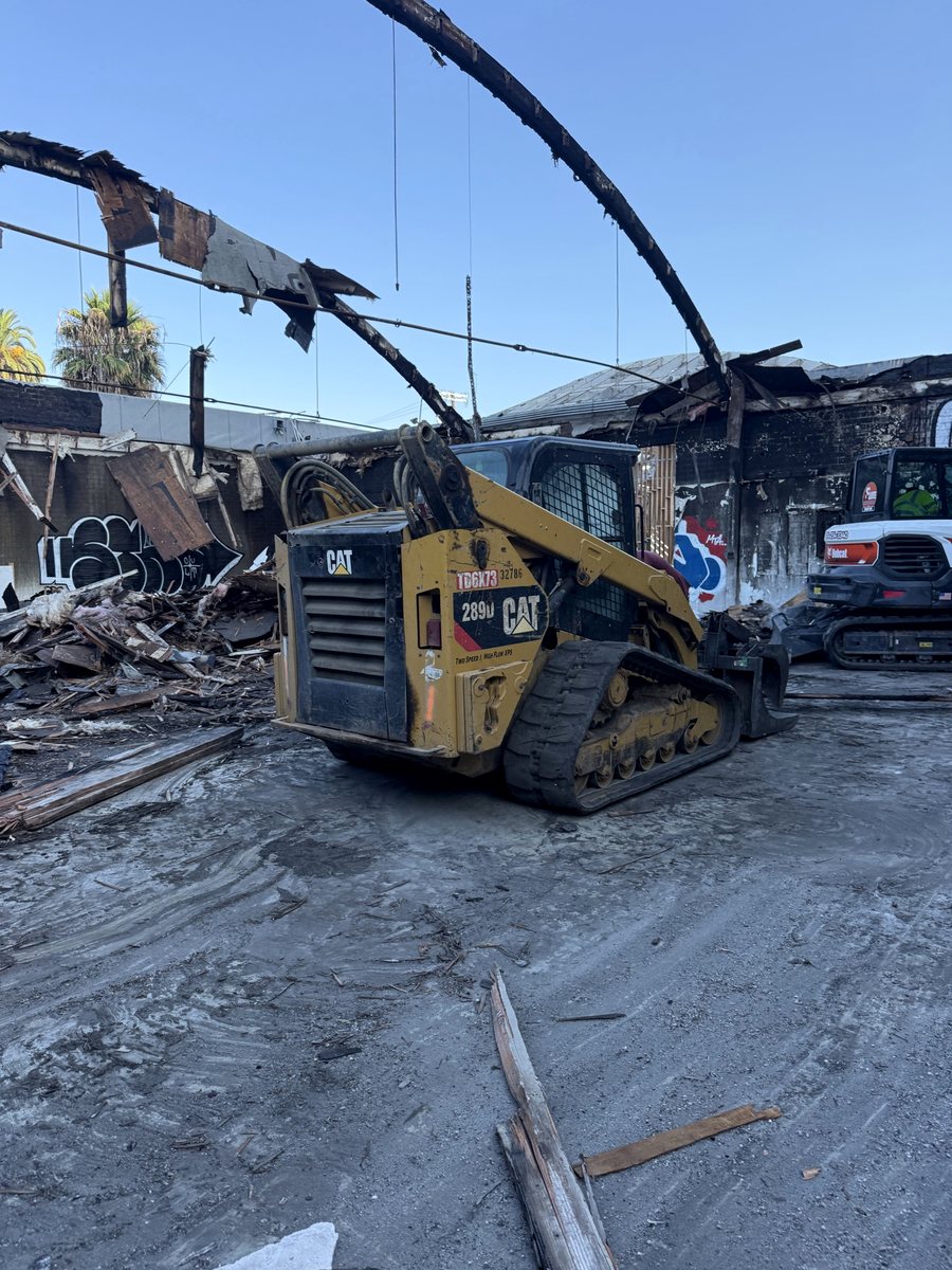 Demo equipment working the debris