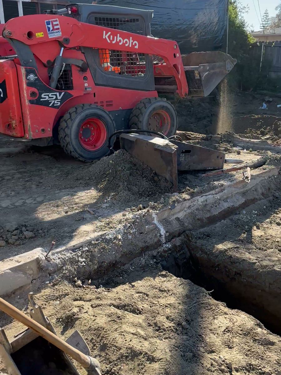 Compact excavator digging footings