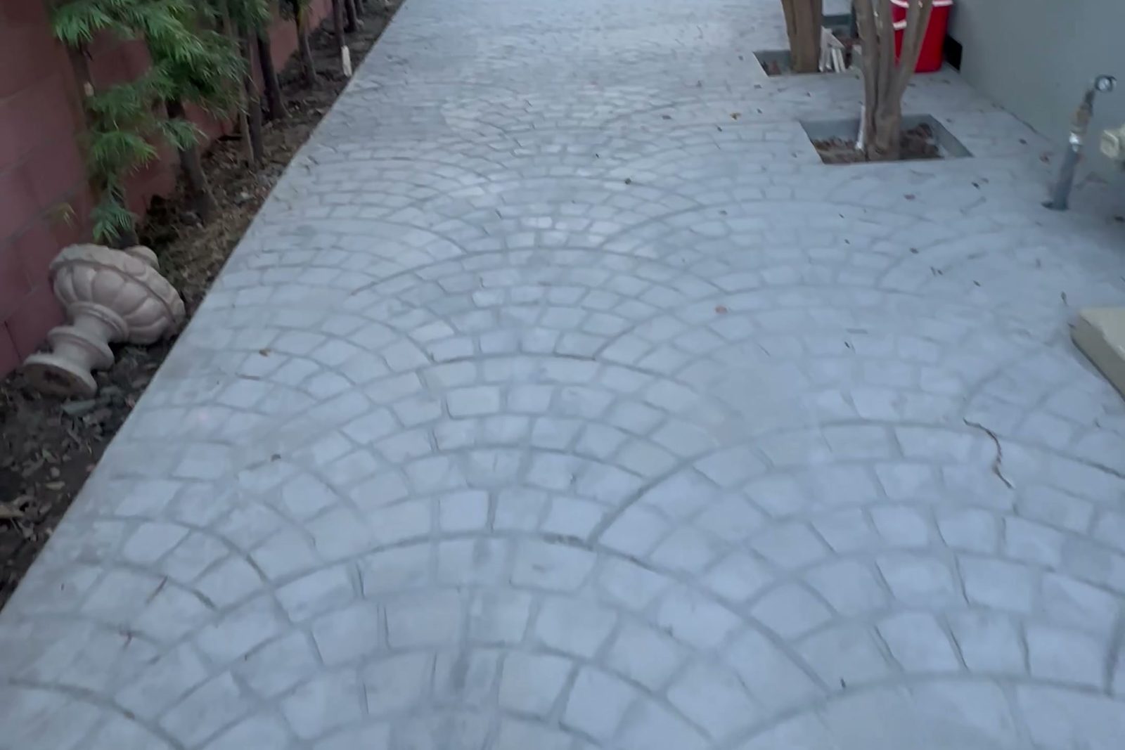 New stamped concrete hardscape along the side yard leading to the finished ADU