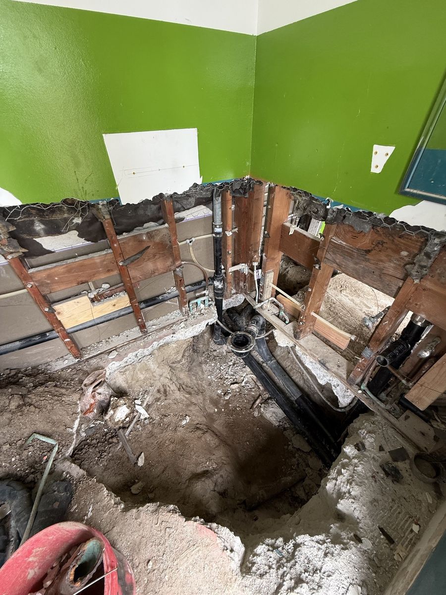 Kitchen wall opened for new plumbing