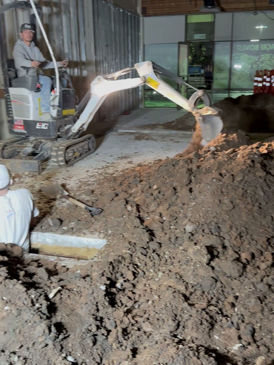 Mini excavator trenching for new drains