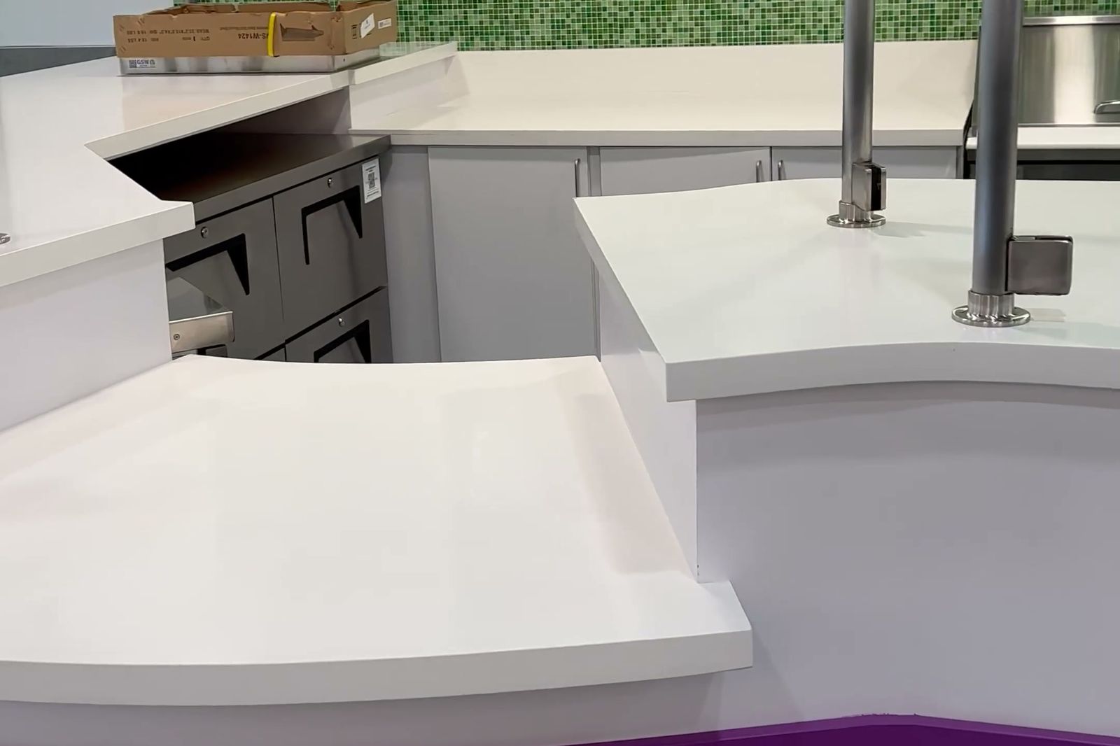Finished Movita Juice Bar curved service counter with purple banding and green feature wall